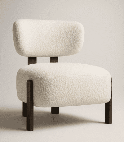 Sella cream upholstered chair with cushioned seat and backrest, supported by dark wooden legs in a minimalist interior setting.