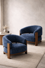 Modern blue upholstered barrel lounge chair with curved back and solid wood legs for luxury living room